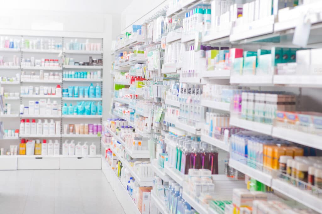 Pharmacy interior with medical and cosmetic goods on shelves